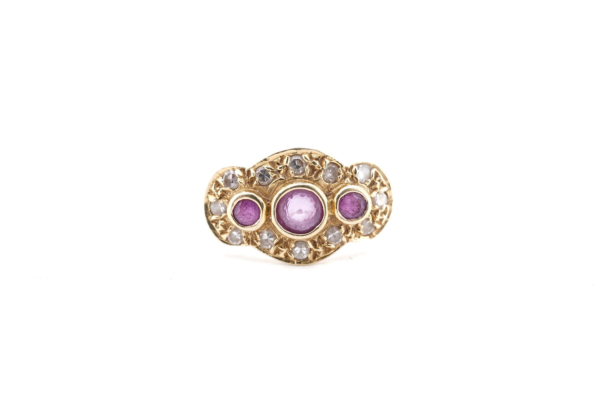 A modern 18ct gold, ruby and diamond cluster ring, the three rubies bordered by small round brilliants, size O, gross weight 2.3 grams.